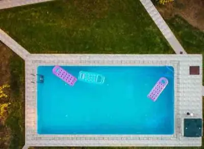 an overhead view of a swimming pool with two pink footprints at Villa Marianna Lygides in Ayiá