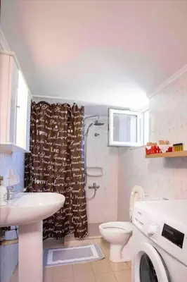 a bathroom with a sink and a toilet and a shower at Villa Marianna Lygides in Ayiá