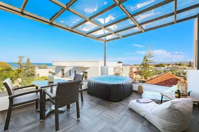 a living room with a view of the ocean at Villa Cicada Chania, steps from the beach, Car included in Agia Marina Nea Kydonias