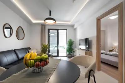 a living room with a table with a bowl of fruit at Comfy Apt terrace and parking 800m to old town and beach in Chania Town