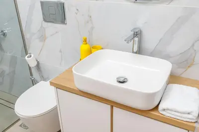 a bathroom with a white sink and a toilet at Meli apartments Paleochora in Palaiochóra