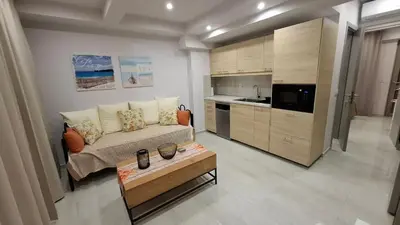 a living room with a couch and a coffee table at Luxious Holiday Apt in Chania Town