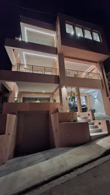 a large apartment building with a lit up facade at Luxious Holiday Apt in Chania Town