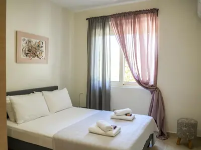a bedroom with a bed with two towels on it at Cisterna Apartment - Shared Pool in Stérnai