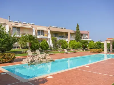 a swimming pool in front of a building at Cisterna Apartment - Shared Pool in Stérnai