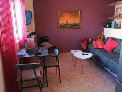 a living room with a couch and a table with a laptop at THE VERANDA OF CHANIA in Chania Town