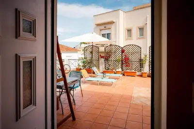 a view of a patio with chairs and an umbrella at THE VERANDA OF CHANIA in Chania Town
