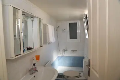 a white bathroom with a sink and a toilet at THE VERANDA OF CHANIA in Chania Town