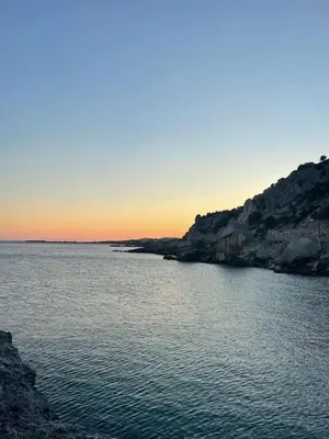 a large body of water with a sunset in the background at Κρητικό Σπίτι Στον Παράδεισο in Palaiochóra