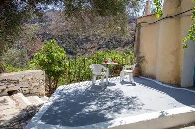 a table and two chairs on a patio with a view at Κρητικό Σπίτι Στον Παράδεισο in Palaiochóra
