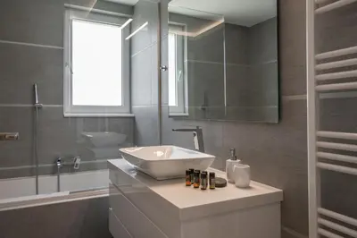 a bathroom with a sink and a mirror at Ardian's home in Chania Town