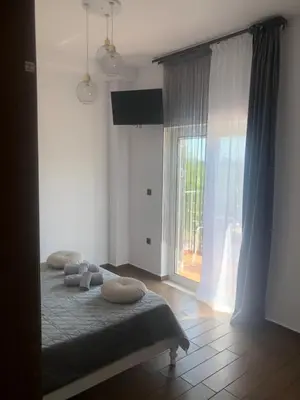 a bedroom with a bed and a large window at Helen in Pírgos Psilonérou