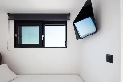 a living room with a window and a couch at Ikon Living Chania in Chania Town