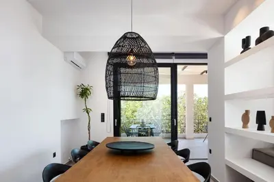 a dining room with a wooden table and chairs at Ikon Living Chania in Chania Town