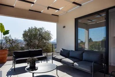 a living room with a couch and a table at Ikon Living Chania in Chania Town