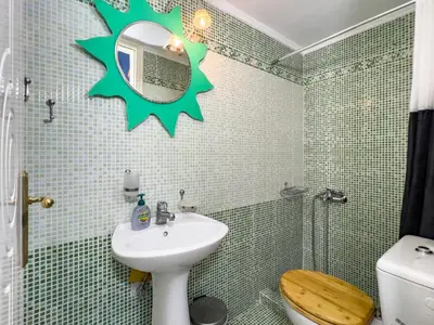 a bathroom with a sink and a toilet and a mirror at Large Cozy House near the sea - Kolimvari Village - 6 Pax in Kolymvari