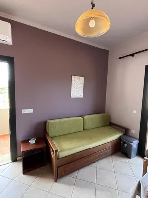 a living room with a green couch in a room at Girogiali Apt 3 in Kamára