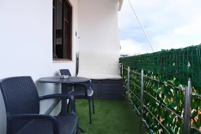 a patio with two chairs and a table on a balcony at Studio92 Chania in Chania Town