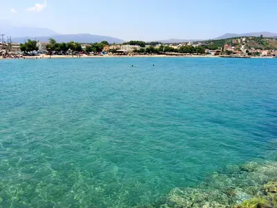 a large body of water with a beach in the background at Villa Amvrosia Nr Kalives Crete in Arménoi