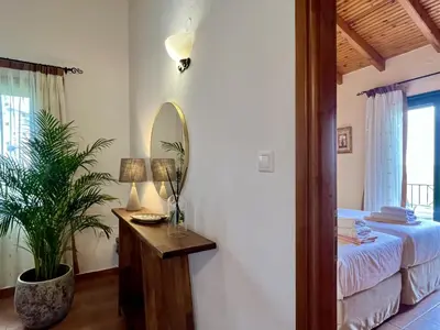 a bedroom with a bed and a mirror at Villa Artemis Vryses Crete in Alikampos
