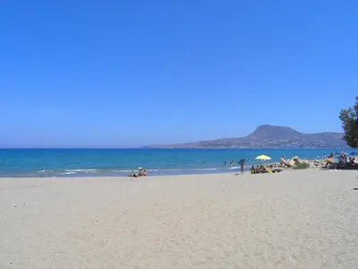 a group of people on a beach with the ocean at Villa Vigla in Samonás
