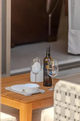 a table with two wine glasses and a bottle of wine at Conte Marino Apartment in Chania Town