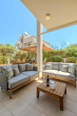 two couches and a coffee table on a patio at Conte Marino Apartment in Chania Town