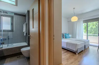 a bedroom with a bed and a tub and a toilet at Conte Marino Apartment in Chania Town