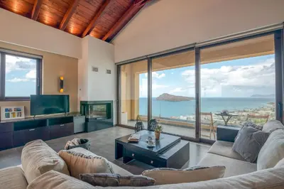 a living room with a couch and a tv at VenMar luxury house in Plataniás
