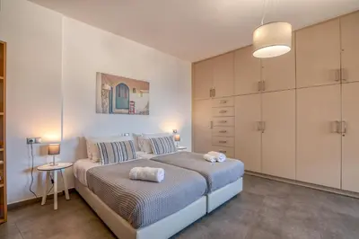 a bedroom with a bed with two towels on it at VenMar luxury house in Plataniás
