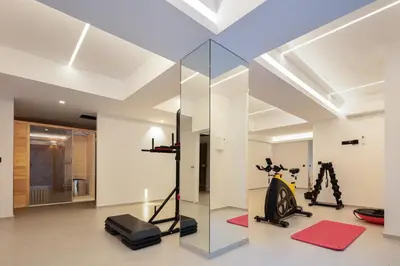 a gym with a treadmill and a glass wall at Avery Villa in Chania Town