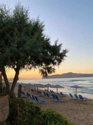 a group of chairs and umbrellas on a beach at Be Crete - Zen Appartments 1 room in Agia Marina Nea Kydonias