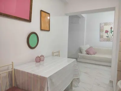 a white room with a table and a couch at Teos App in Chania Town