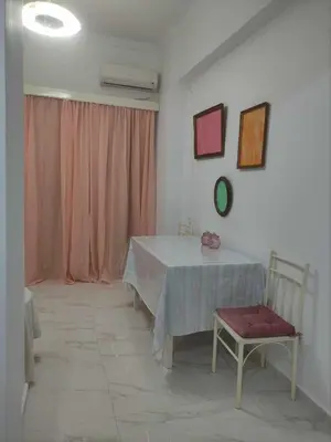 a dining room with a table and a chair at Teos App in Chania Town