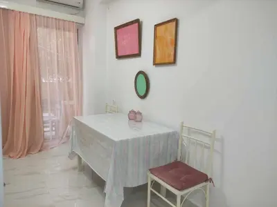 a dining room with a table and two chairs at Teos App in Chania Town