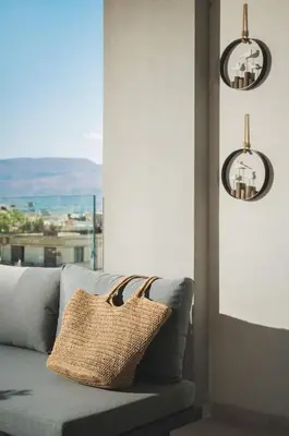 a couch in a living room with a window at Afrodite-Μεζονέτα στην πόλη Χανιά in Chania Town