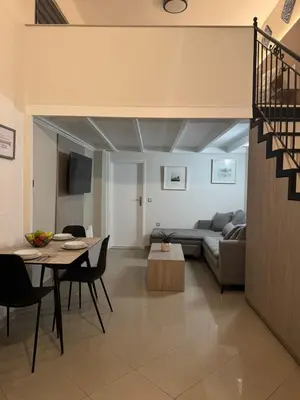 a living room with a couch and a table at Foumidon Apartments, Chania in Chania Town