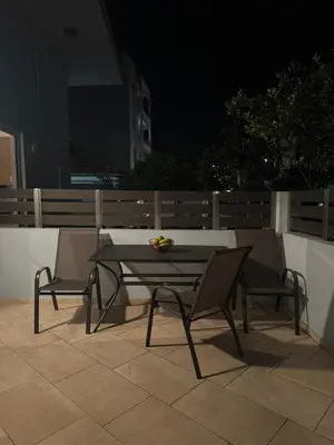 a table and chairs on a patio at night at Foumidon Apartments, Chania in Chania Town