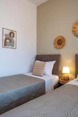 two beds sitting next to each other in a room at Armeria Apartments I I in Daratso