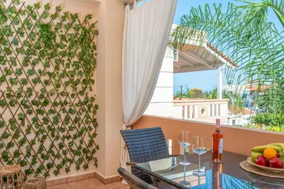 a dining room with a table and a window at Armeria Apartments I I in Daratso