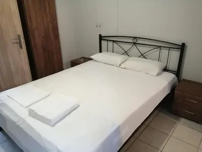 a bed with two white pillows on top of it at Ελευθέριος, rooms 1 in Chania Town