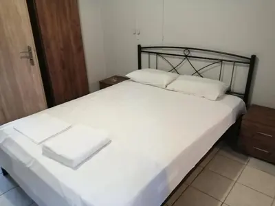 a bed with two white pillows on top of it at Ελευθέριος, rooms 1 in Chania Town
