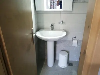 a bathroom with a sink and a toilet at Ελευθέριος, rooms 1 in Chania Town