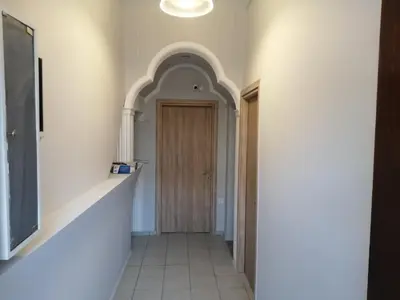 a hallway with a wooden door in a room at Ελευθέριος, rooms 1 in Chania Town