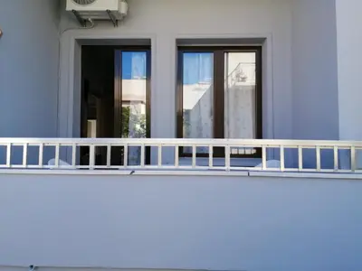 a balcony in front of a building with windows at Ελευθέριος rooms 2 in Chania Town