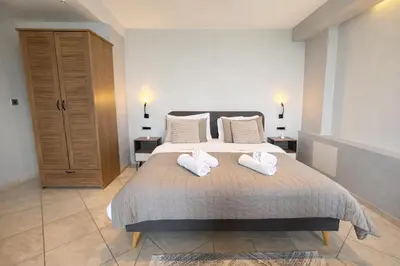a bedroom with a bed with two towels on it at Endless blue suites 3 in Chania Town