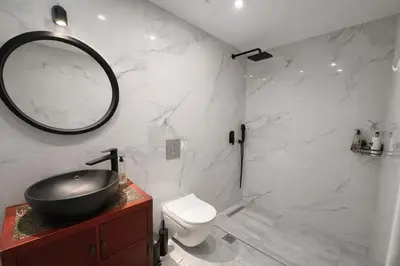 a bathroom with a sink and a toilet and a mirror at Endless blue suites 4 in Chania Town