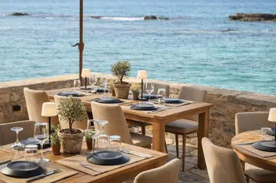 a table set up for a meal with the ocean in the background at Endless blue suites 4 in Chania Town