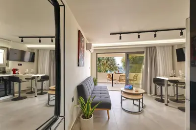 a living room with a couch and a table at Callista Seafront Studio in Chania Town