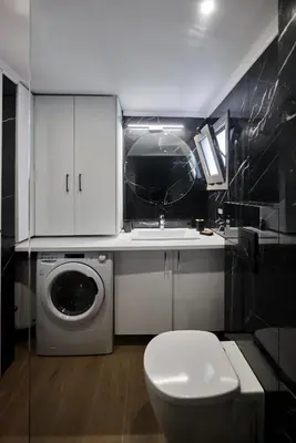 a bathroom with a sink and a washing machine at Callista Seafront Studio in Chania Town